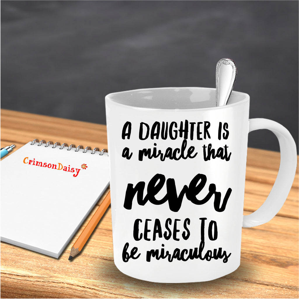 A Daughter is A Miracle that Never Ceases to be Miraculous Coffee Mug in the table